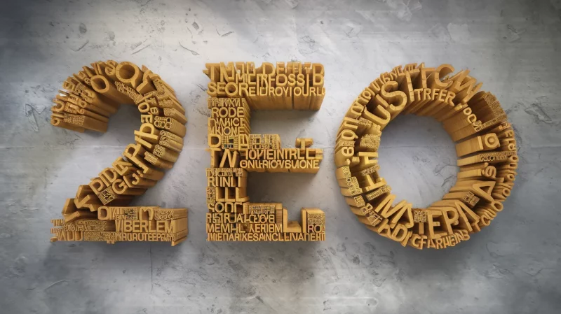 Il numero "2020" è rappresentato in formato testo 3D, con varie piccole parole che compongono ogni cifra, disposte su uno sfondo grigio testurizzato.